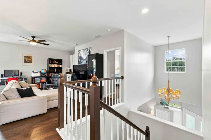 An open loft landing overlooks the foyer below, connecting the upstairs living space to the rest of the home