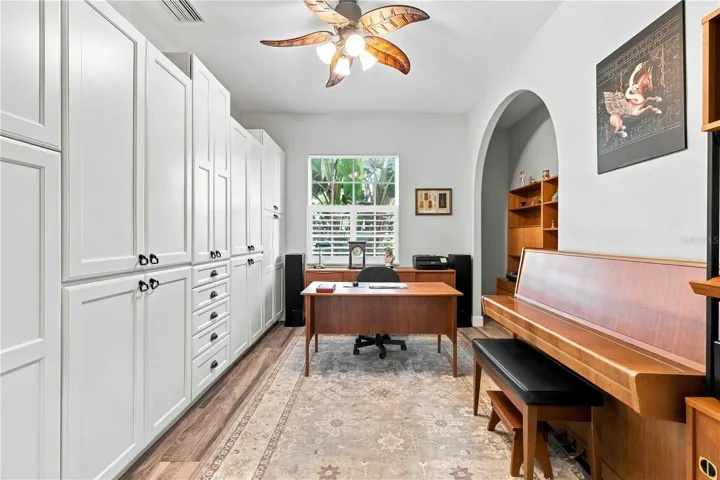 A versatile home office with wall-to-wall custom storage — room to work, create, or play