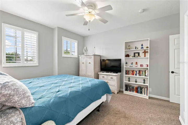 Generous windows and built-in bookshelf storage add both light and function to the upstairs primary retreat.
