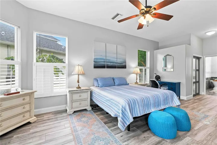Multiple windows and a private sitting nook make this primary suite feel like its own wing of the home
