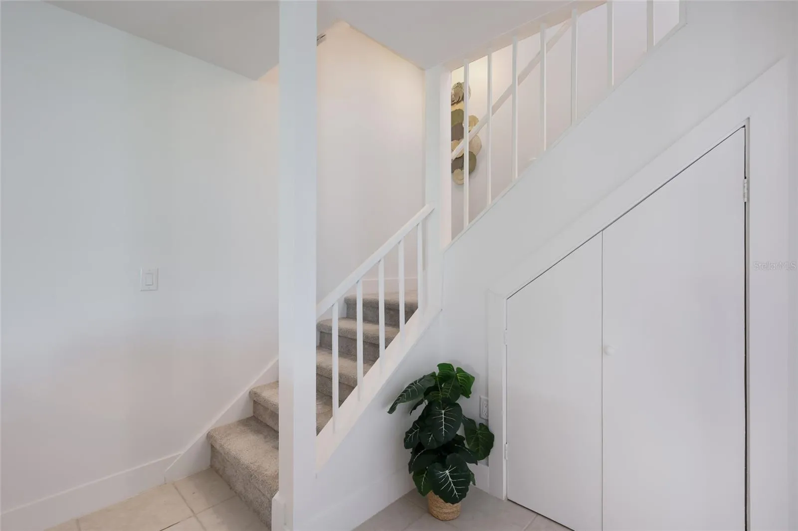 Stairway to two bedrooms and two full bathrooms