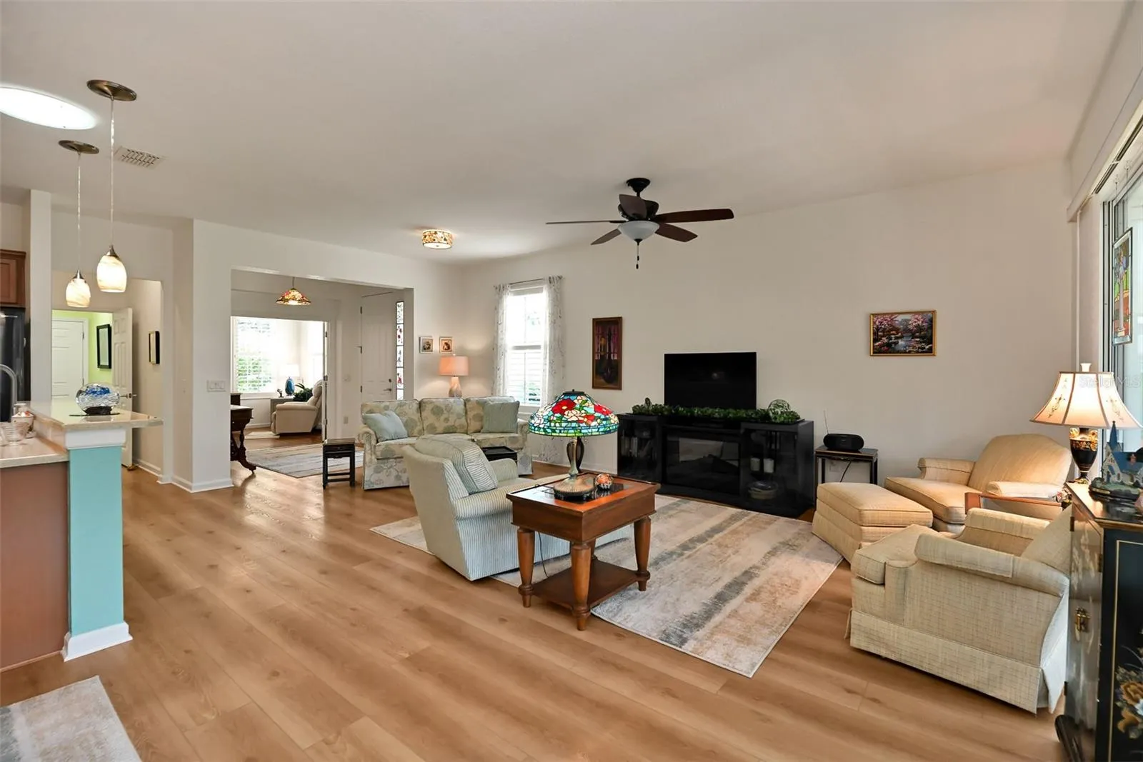 Open concept Living/Dining Areas with luxury vinyl plank flooring and included fireplace console.
