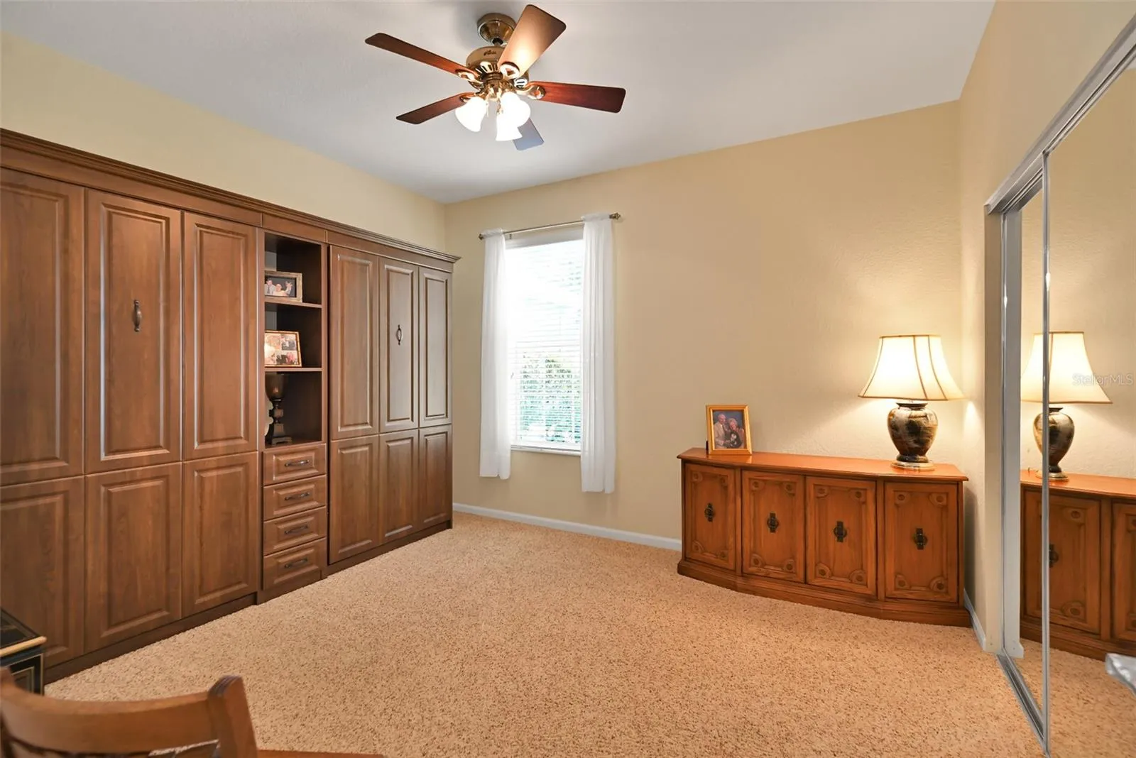 Guest bedroom with included twin Murphy beds, ceiling fan & mirrored closet doors