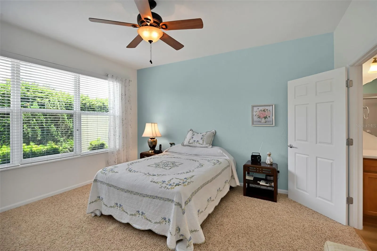 Primary bedroom with ceiling fan & ensuite bath