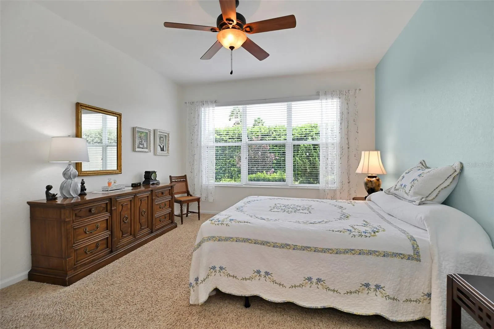Primary bedroom with ceiling fan & ensuite bath
