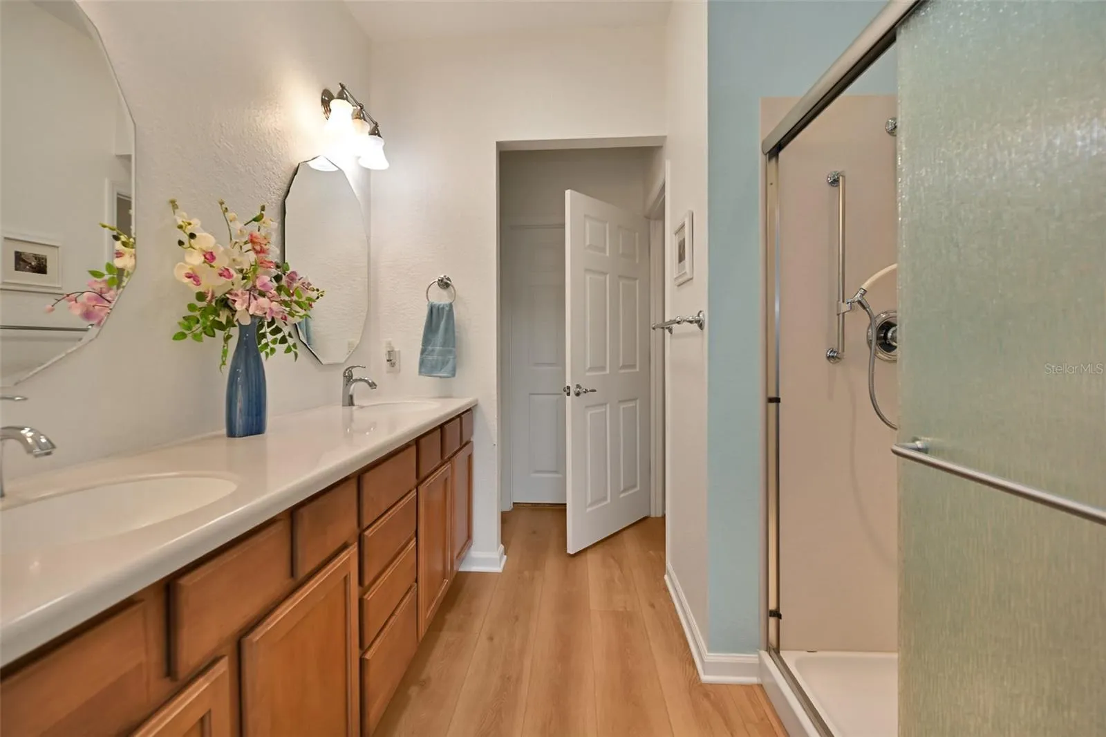 Primary ensuite bath with double vanity, walk-in shower, private commode, linen closet & walk-in closet