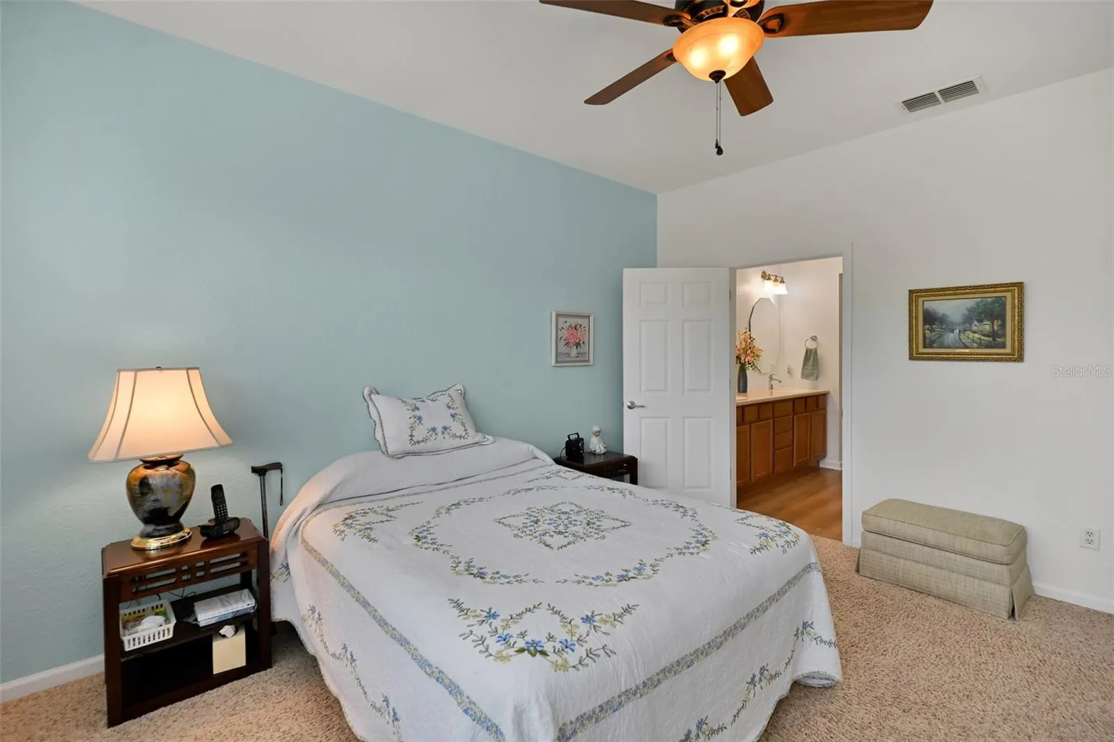 Primary bedroom with ceiling fan & ensuite bath