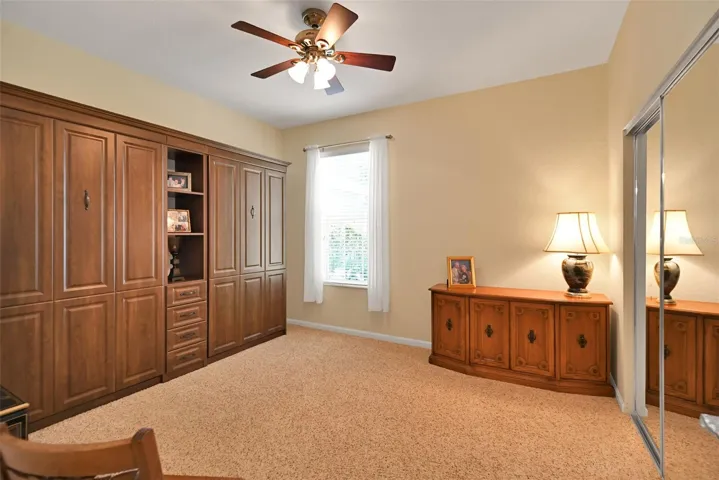 Guest bedroom with included twin Murphy beds, ceiling fan & mirrored closet doors