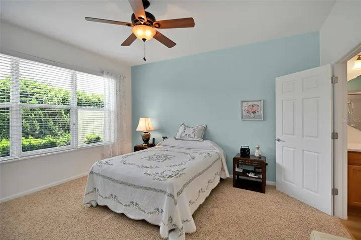 Primary bedroom with ceiling fan & ensuite bath
