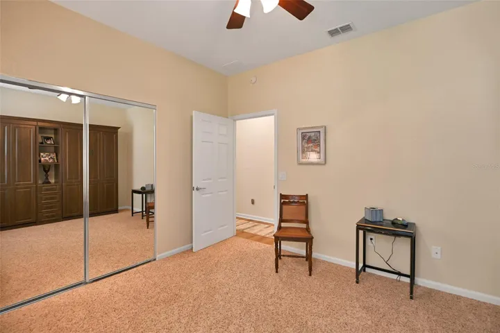 Guest bedroom with included twin Murphy beds, ceiling fan & mirrored closet doors