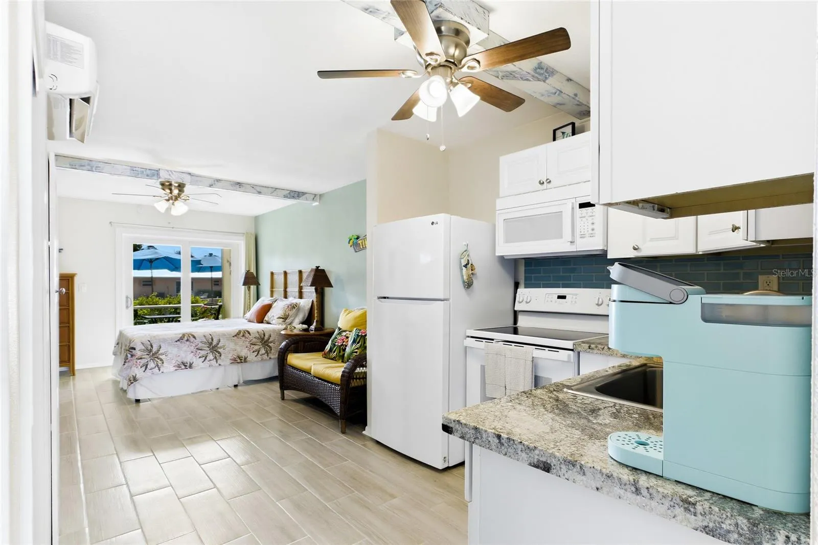 THE PALM ROOM Each thoughtfully designed studio features an open bedroom and living area, creating a comfortable and functional space with a fresh coastal feel.
