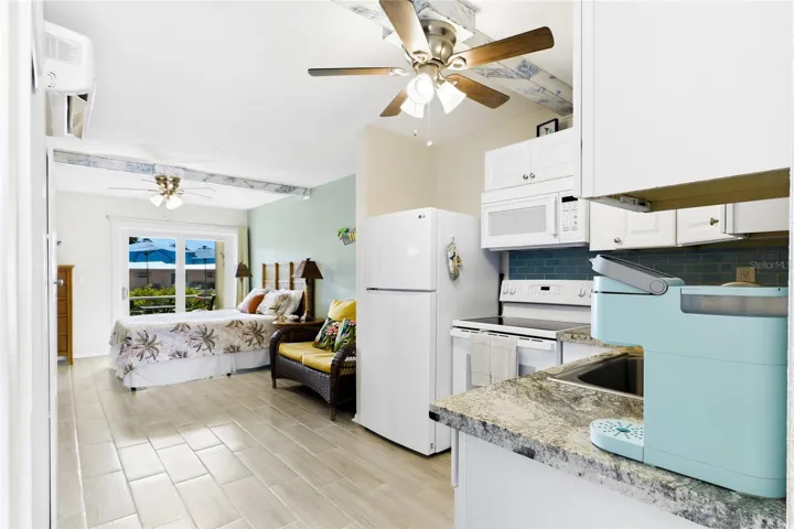 THE PALM ROOM Each thoughtfully designed studio features an open bedroom and living area, creating a comfortable and functional space with a fresh coastal feel.