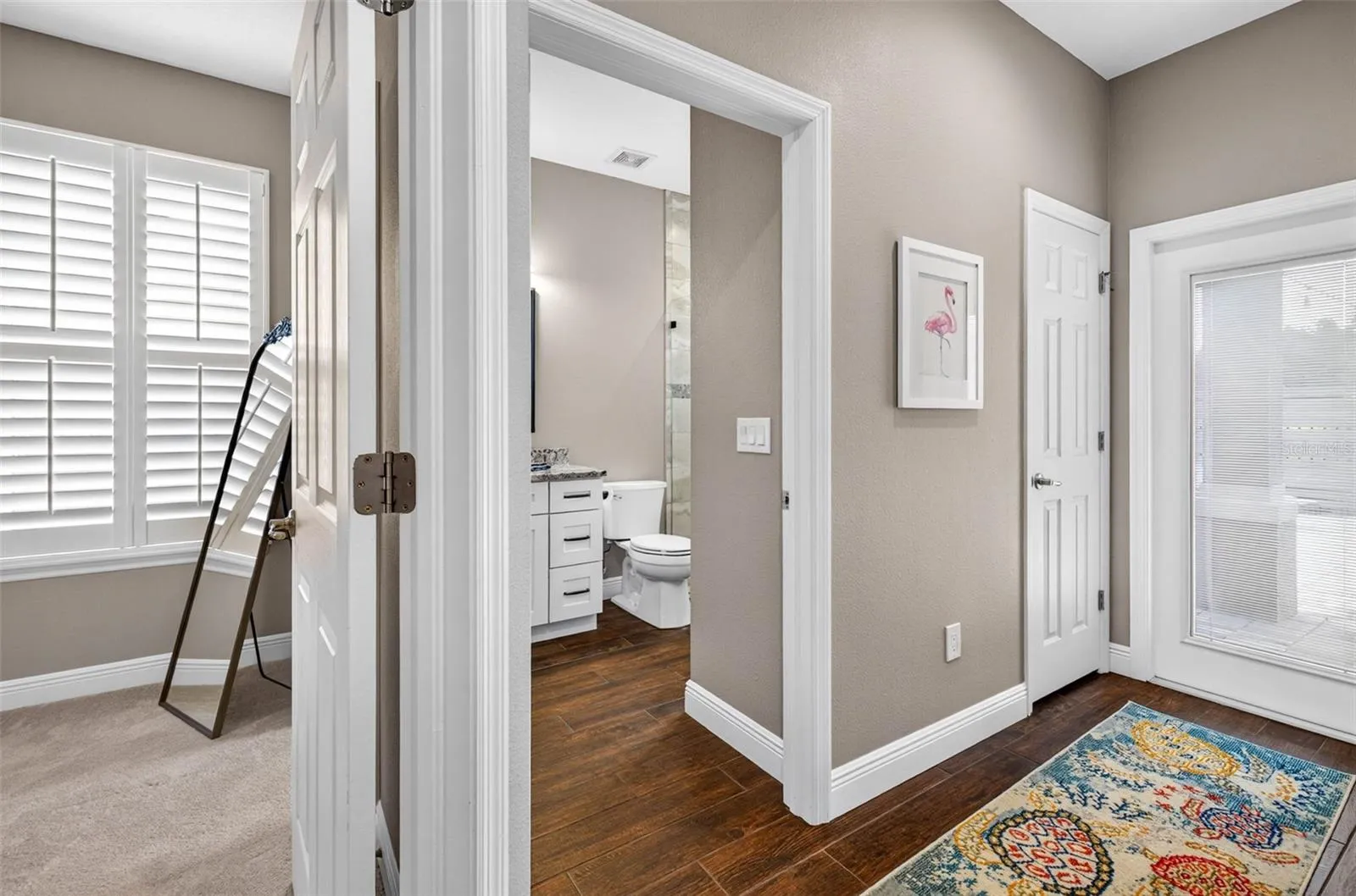 Bedroom 3 with connected bathroom. Door to patio