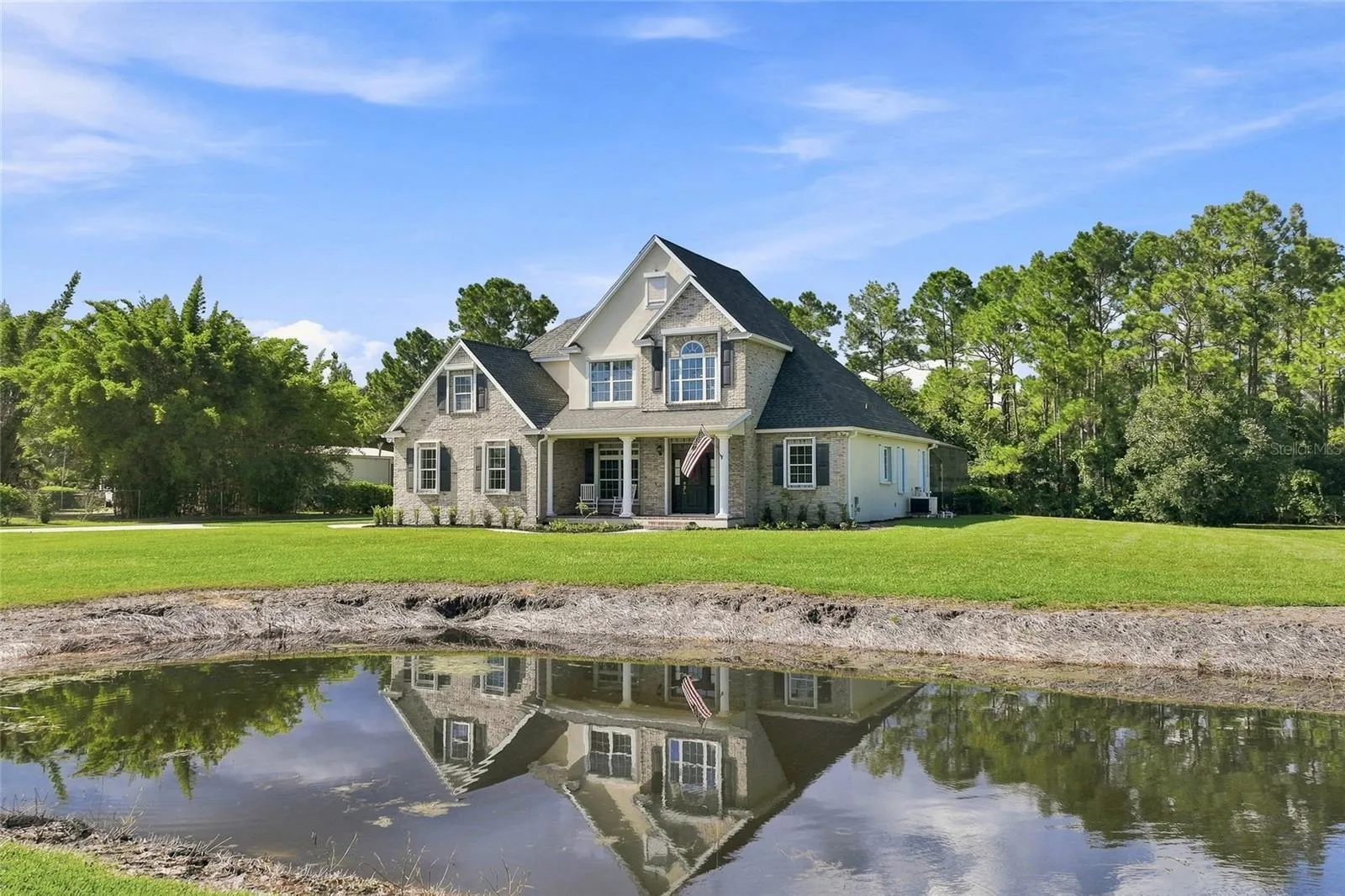 Front of home with pond view