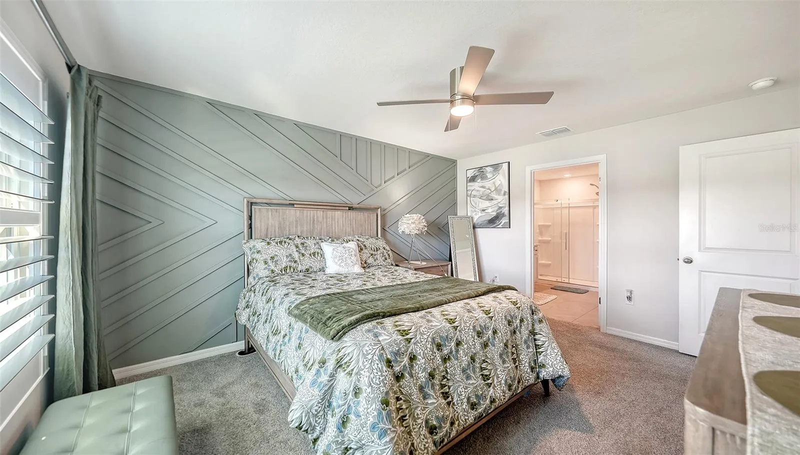 Upgraded designer wall and ceiling fan in the primary bedroom.