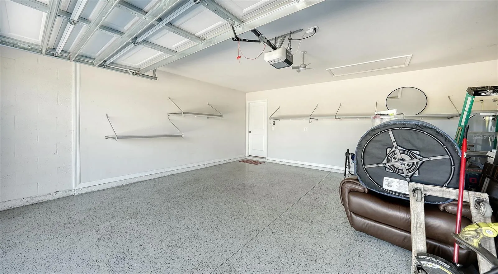The garage has upgraded epoxy flooring as well as storage racks for your convenience.