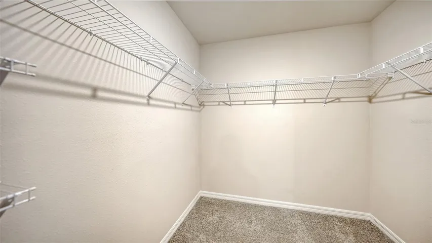 Primary bedroom spacious walk-in closet.
