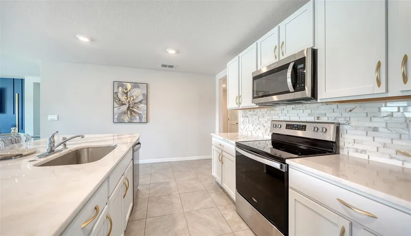 Upgraded backsplash and cabinet hardware.