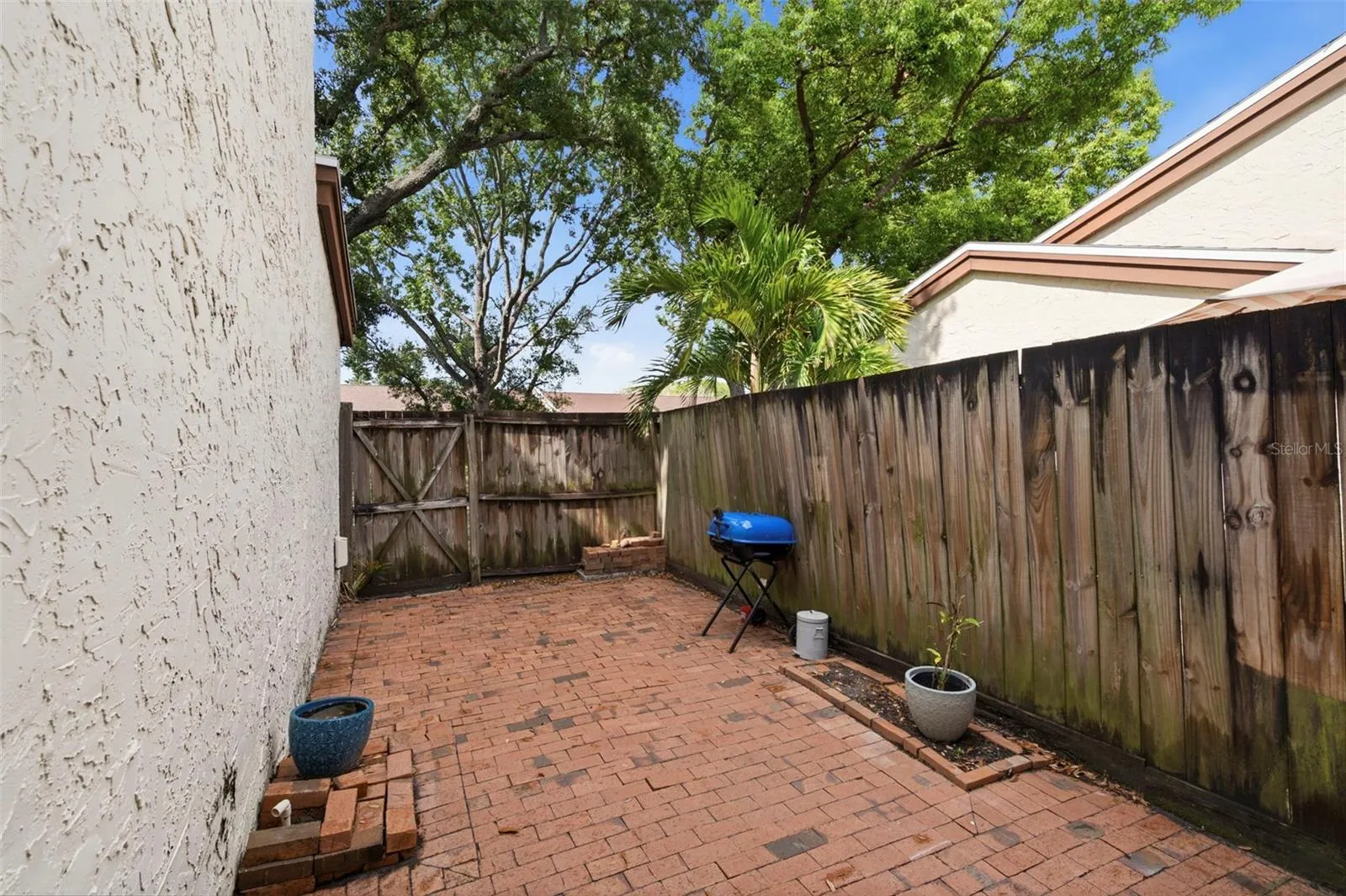 Large, fenced, paver pater in the back.