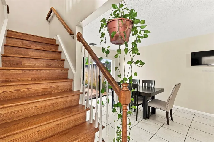 Solid wood flooring on stairs leads to 3 upstairs bedrooms and 2 bathrooms.