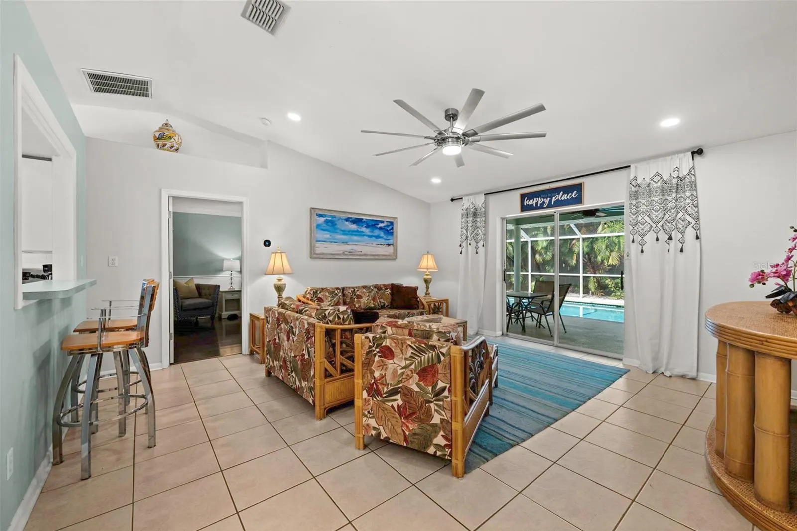 Living room as you enter, looking straight through to the pool