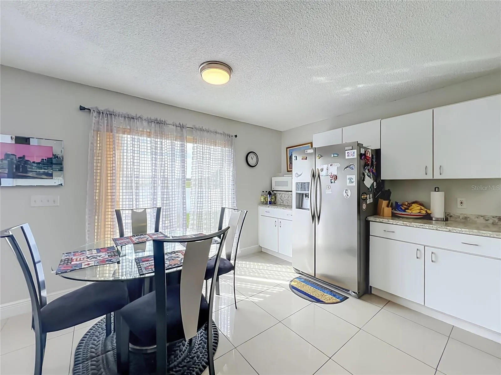 Dinette area in kitchen with sliding doors to the back yard and pond front
