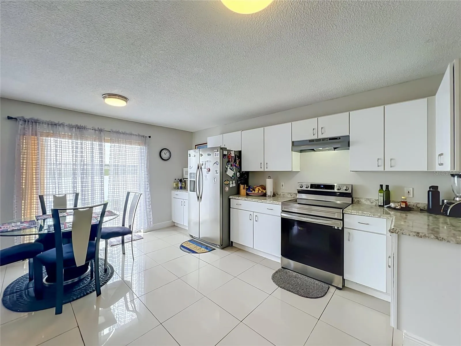Dinette area in kitchen with sliding doors to the back yard and pond front