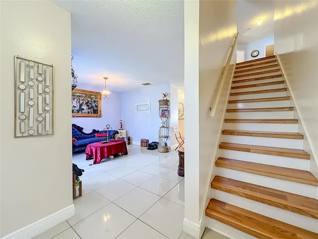 First floor is all ceramic tile, and wood leads to upstairs where all floors are wood laminate