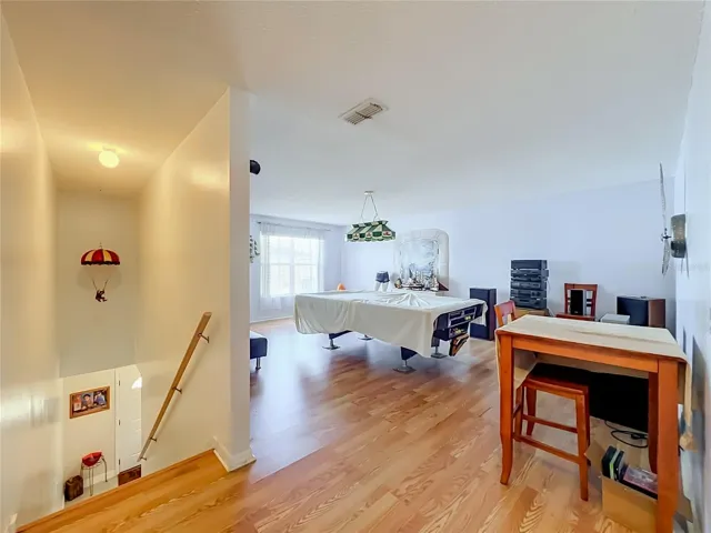 Wood laminate floors up the stairs and in the whole 2nd floor. This is a view of the large bonus room which could be a 5th bedroom if desired because there is a large closet currently used as an office.