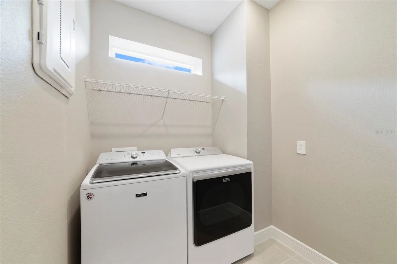Walk-in laundry room with natual light