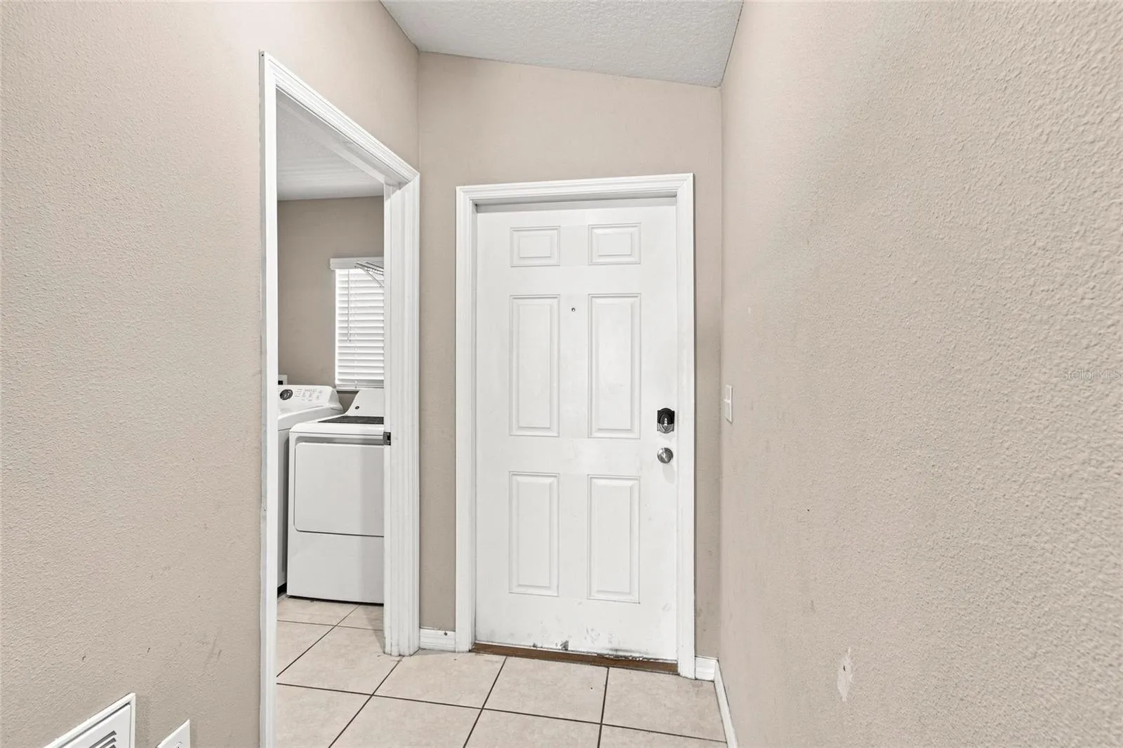 Front door and doorway to laundry