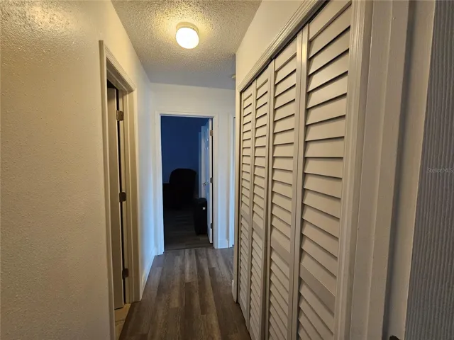 Hallway Between Bedrooms with 2nd Bathroom and Laundry Closet