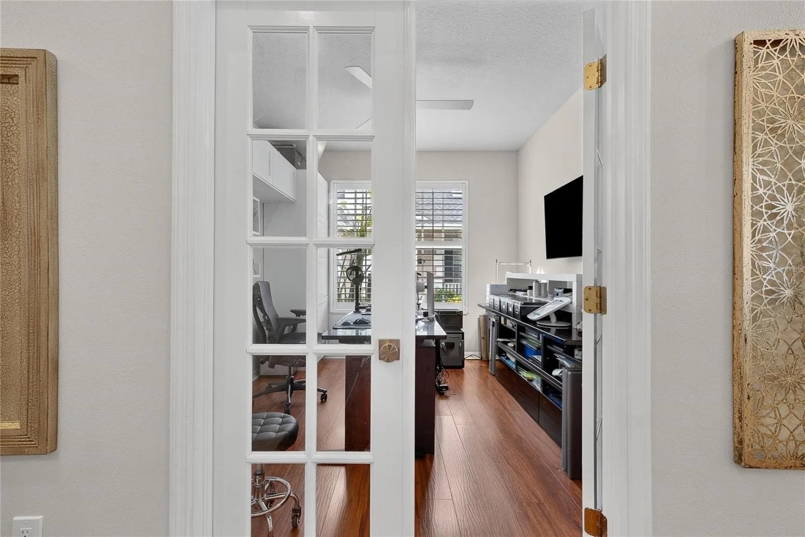 French doors open to a private den, ideal for a home office, study or flex space