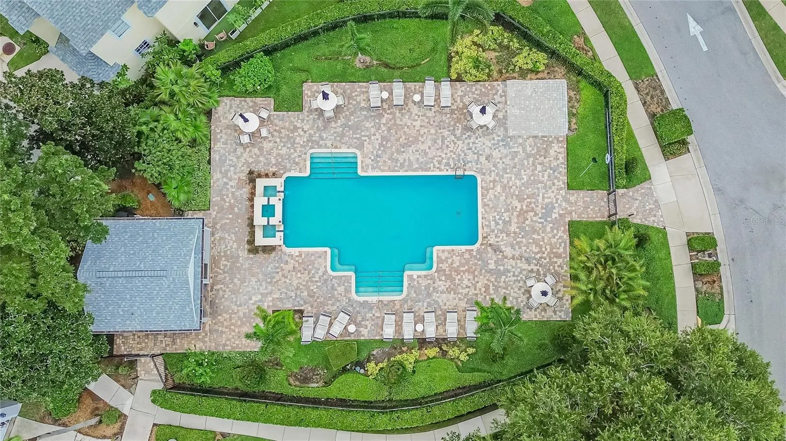 Community pool with expansive paver deck and plenty of space to relax and enjoy the Florida sunshine.