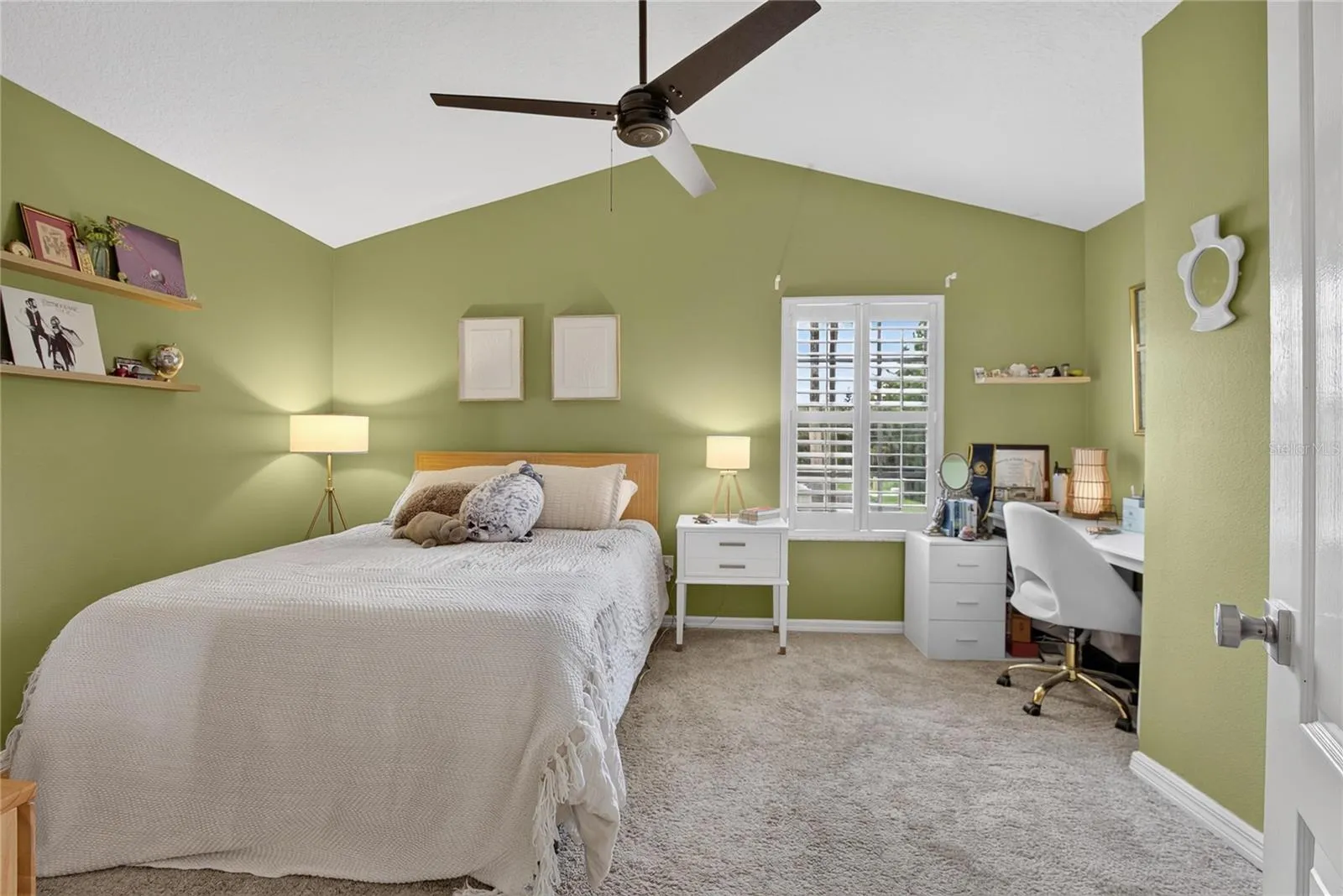 Spacious secondary bedroom with vaulted ceiling, plantation shutters and plenty of room for a desk or study area.