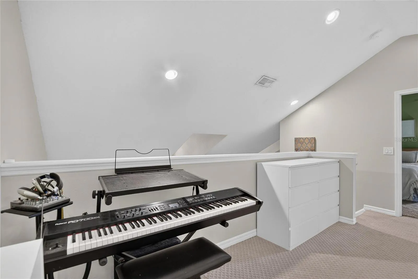 Versatile loft overlooks the main living area and connects to the upstairs bedrooms.