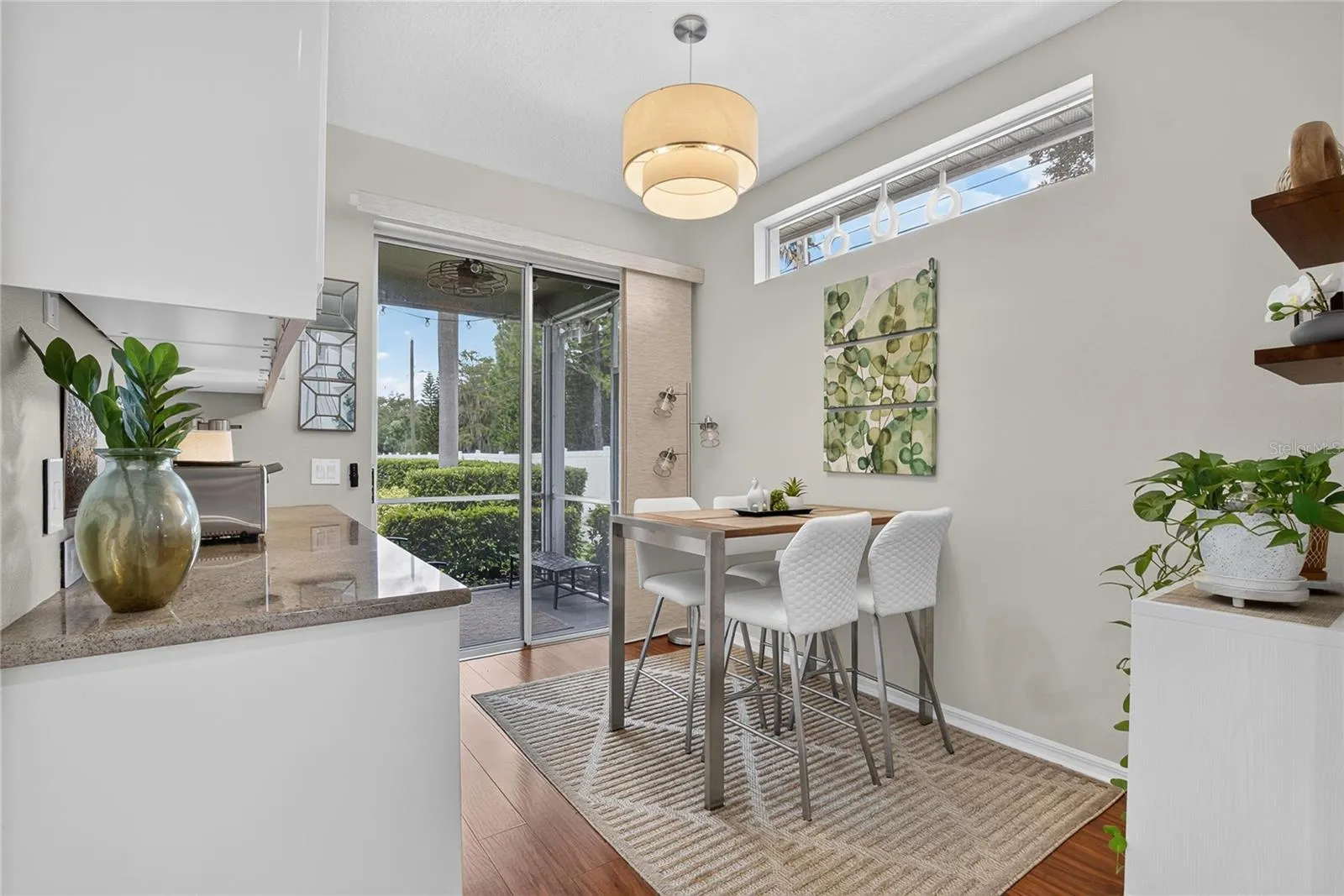 Sunny breakfast nook with high ceilings and direct access to the screened lanai