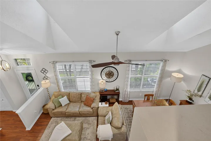 Loft overlooks the open living and dining areas below, highlighting the home’s soaring ceilings and open-concept design.