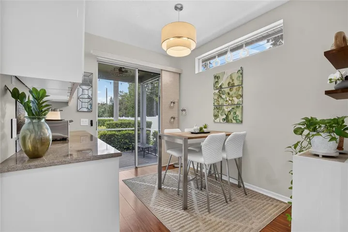 Sunny breakfast nook with high ceilings and direct access to the screened lanai