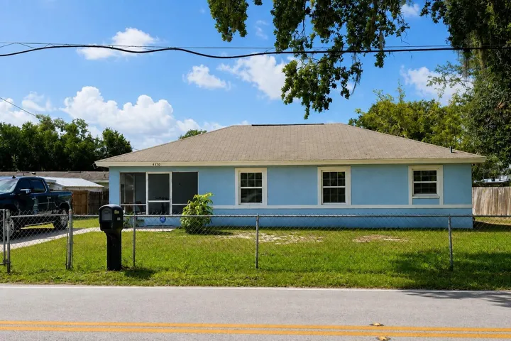 A spacious fenced yard, mature shade trees, and a screened front entry.