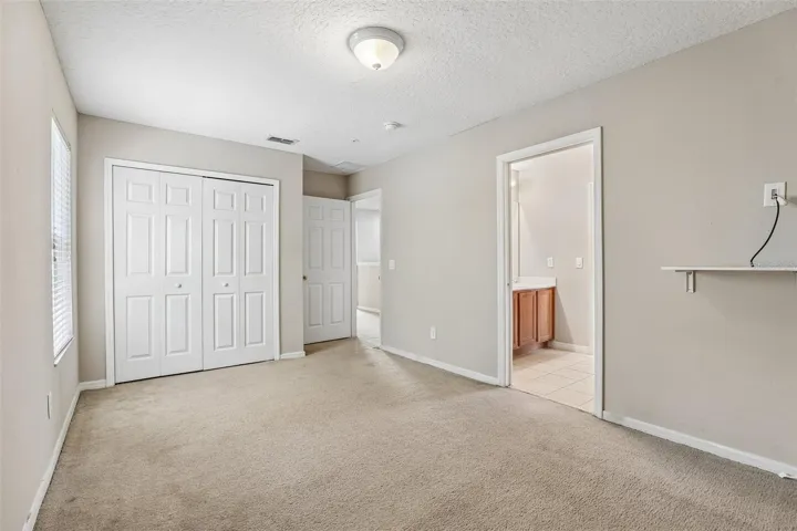Third bedroom, en-suite access to a shared bath.