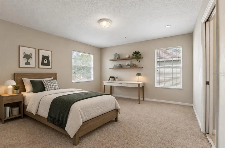 Second bedroom, en-suite access to a shared bath. Virtually Staged.
