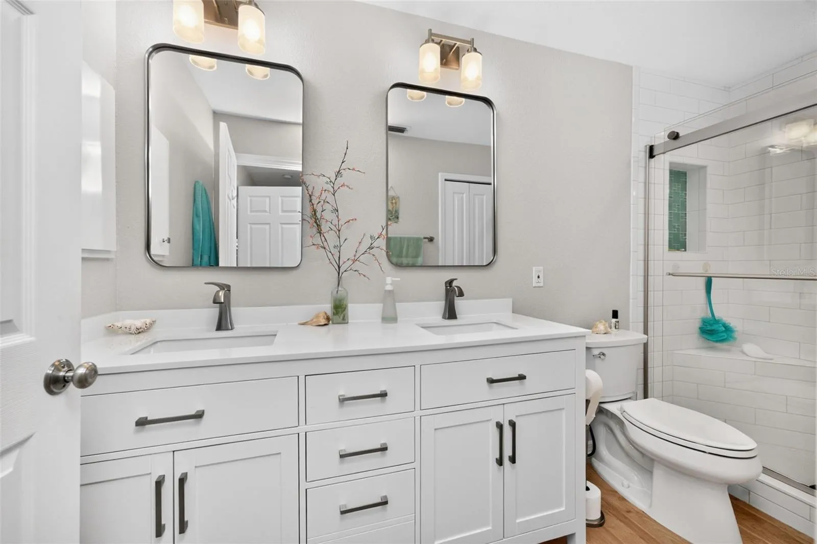 The primary bathroom is completely updated with new vanity w/solid surface countertop & double basins, new mirrors & lighting, new toilet and has a linen closet.