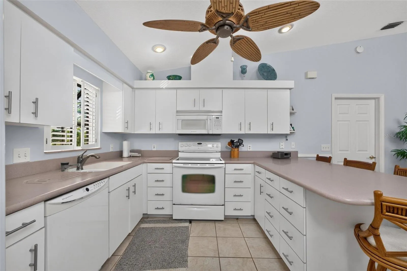 The kitchen also has a Maytag smooth top stove, Frigidaire dishwasher & microwave, a ceiling fan and plenty of storage.