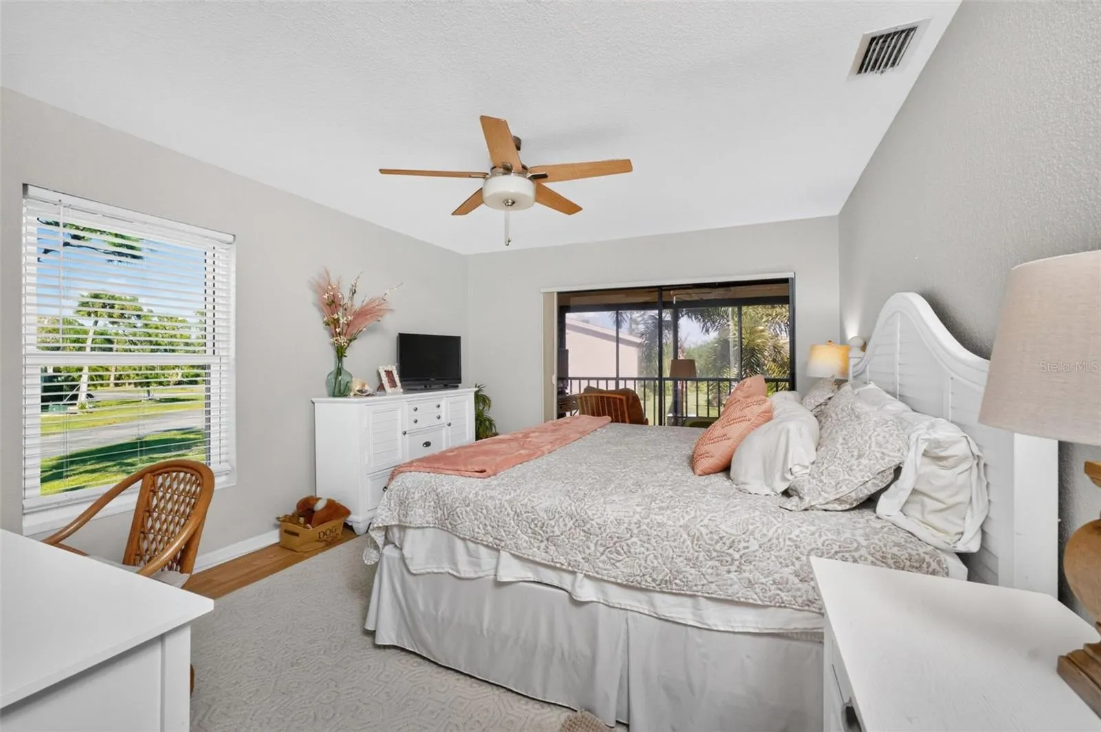 The primary bedroom has laminate flooring, sliding glass doors to the lanai and lots of natural light!