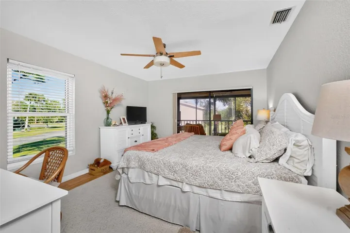 The primary bedroom has laminate flooring, sliding glass doors to the lanai and lots of natural light!