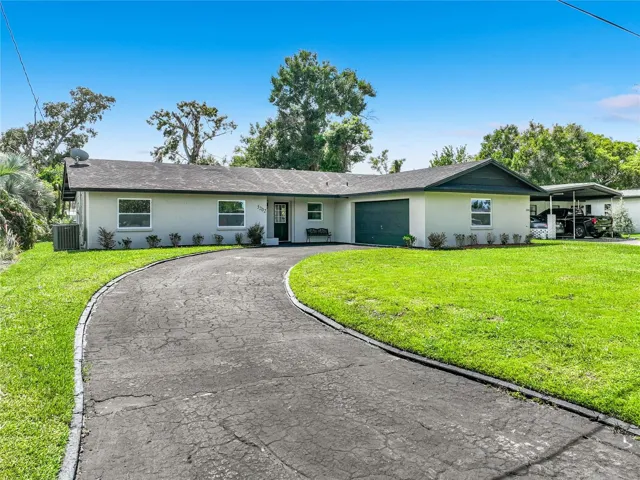 Welcome home—renovated Orlando living with a circular driveway and canal access.