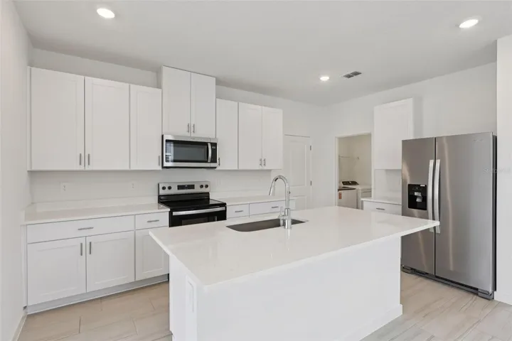 The interior photos are of another home with the same floor plan but different interior color package finishes. Some details may vary
