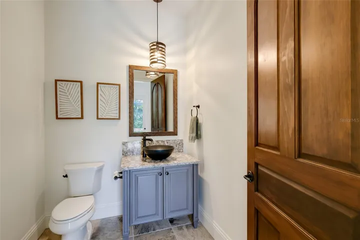 Guest powder bath doubles as pool bath.