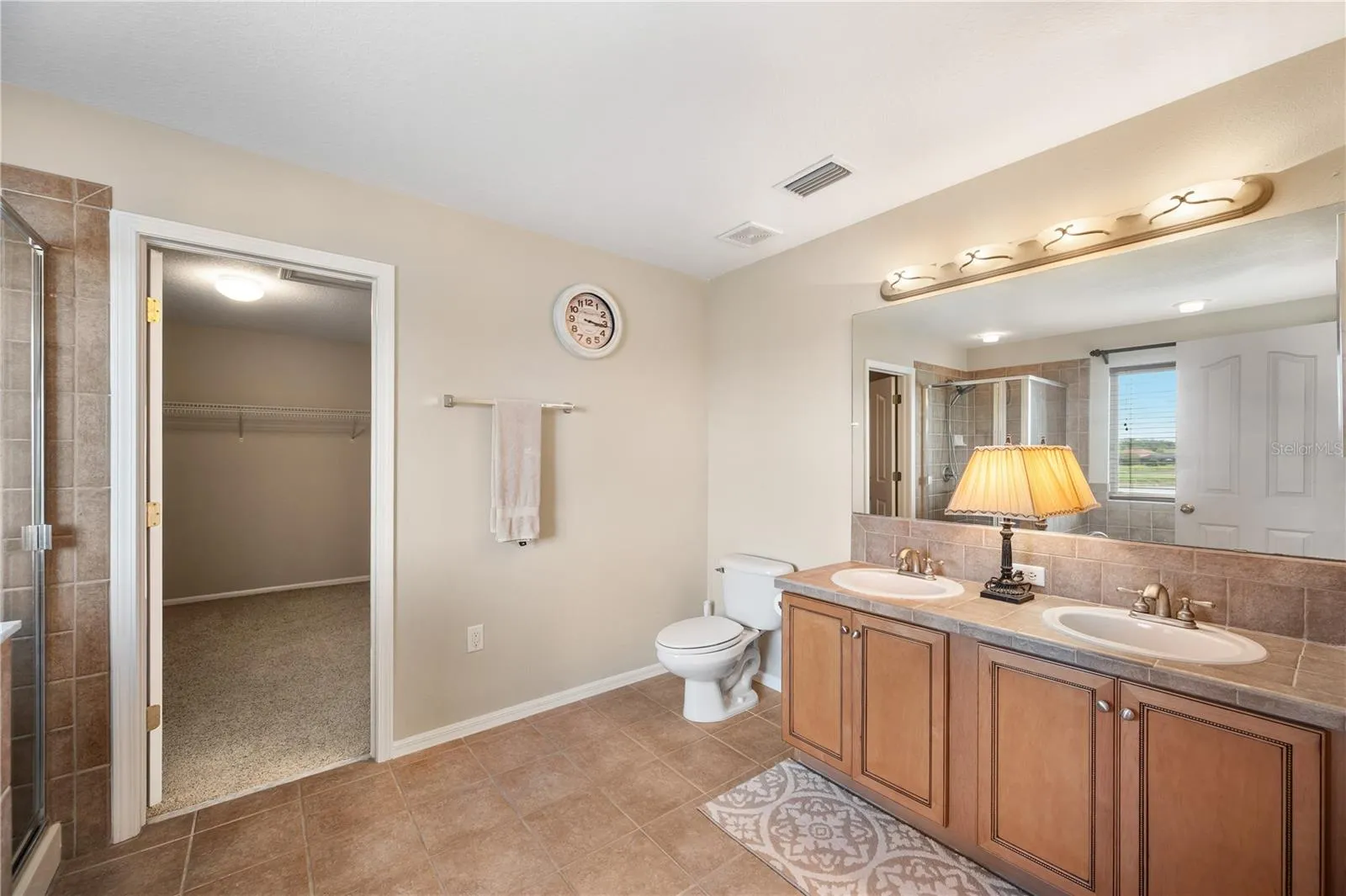 Primary bath and a view into a HUGE Primary closet.